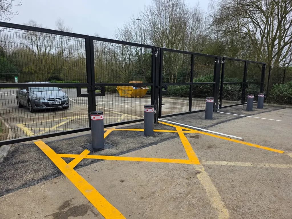 Line of automatic rising bollards protecting a marked car park bay