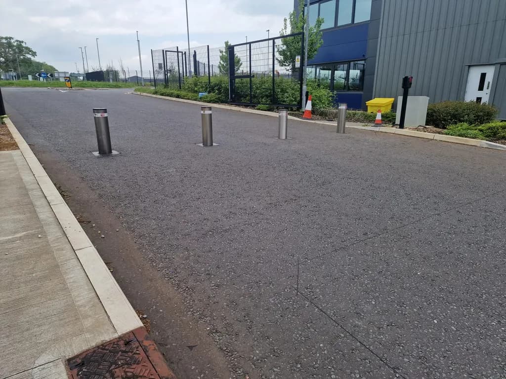 Line of automatic bollards restricting vehicle access on a shared street