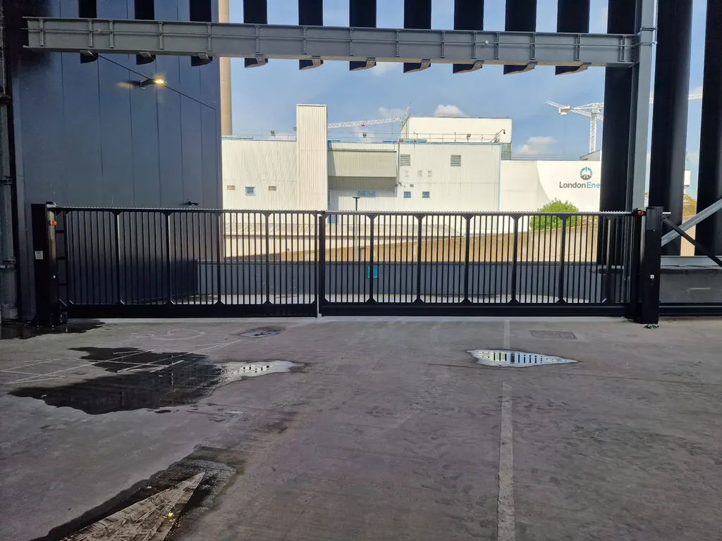 Bar gates at a factory yard entrance, seen from inside the loading area