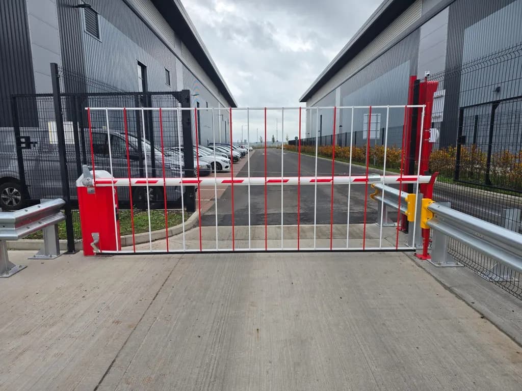 Rising-arm barrier controlling the service road between two warehouse units
