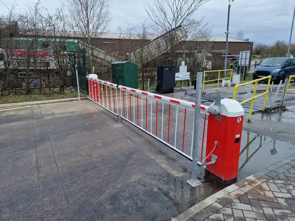 Red and white barriers controlling a retail service road