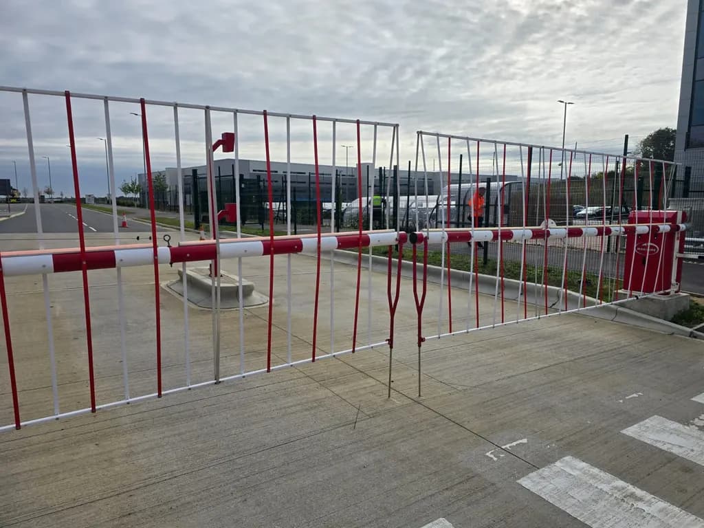 Rising-arm barriers and mesh fencing securing a commercial yard