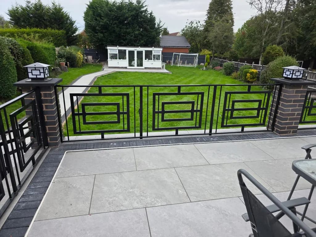 Decorative metal railings enclosing a landscaped garden terrace