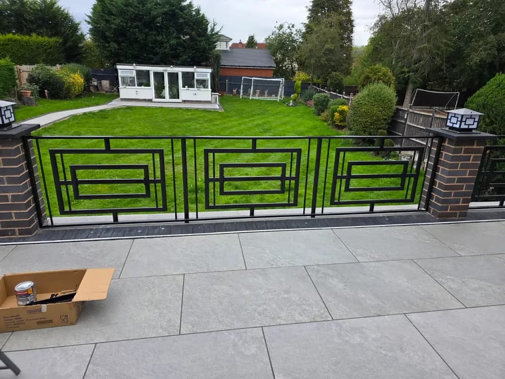 Decorative metal railings along a raised garden terrace