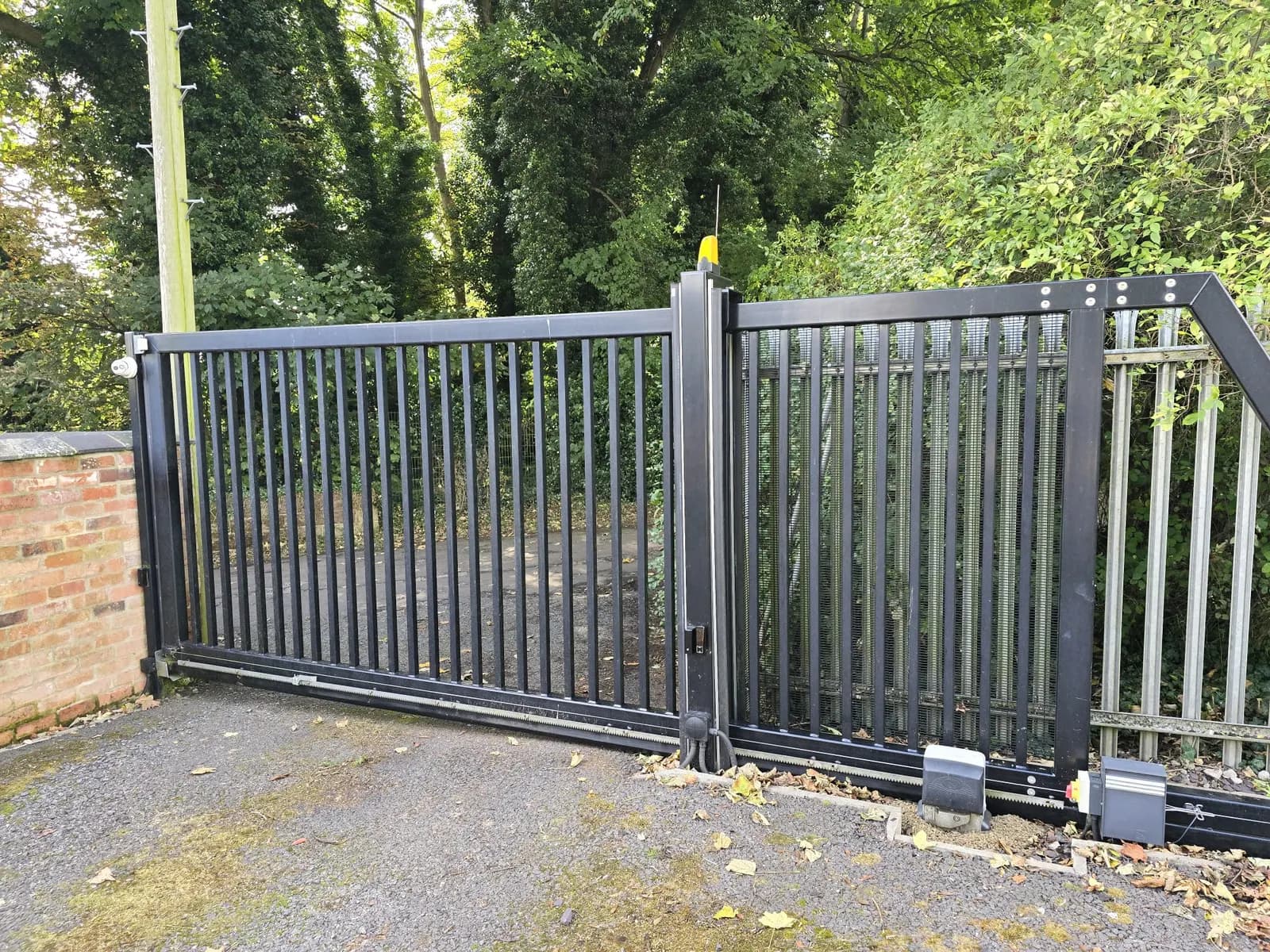 Existing metal gates on an older installation, prior to a controls and safety upgrade