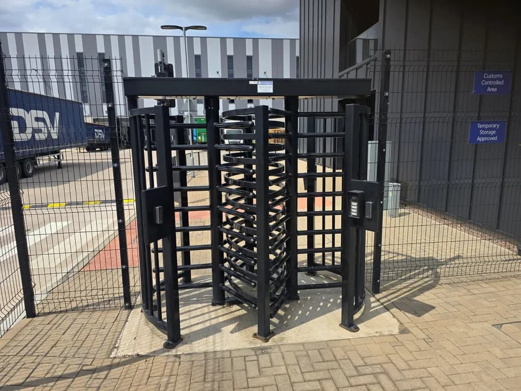 Full-height turnstiles controlling pedestrian entry at a logistics depot