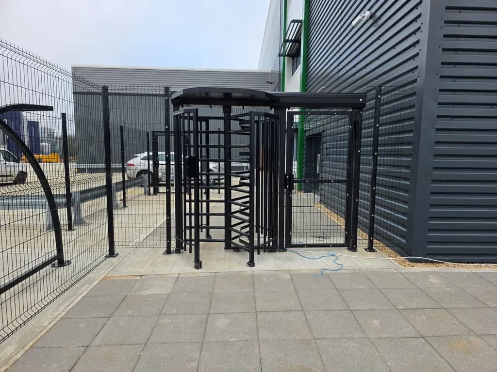 Full-height security turnstile controlling pedestrian access at a site entrance