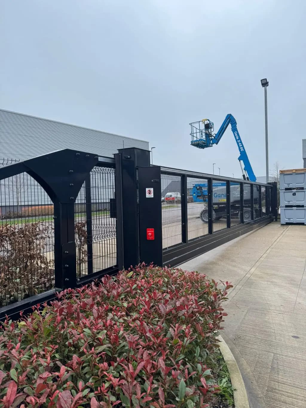 Gate installation under way, with an access platform positioned at the gate post