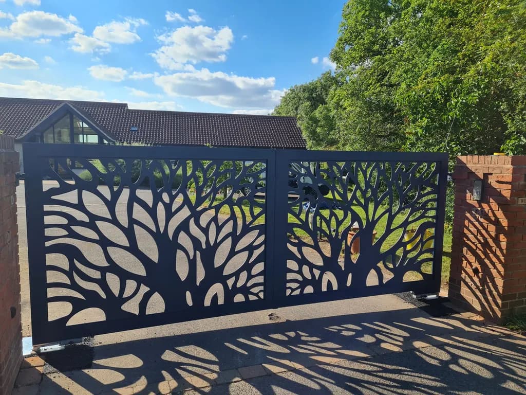 Laser-cut steel gates in a tree design, automated on a private driveway