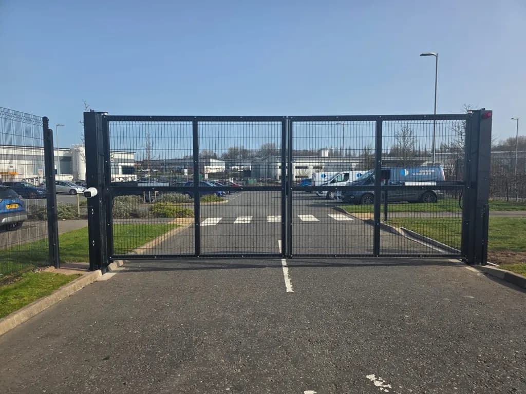 Pair of mesh-infill swing gates across a commercial site entrance