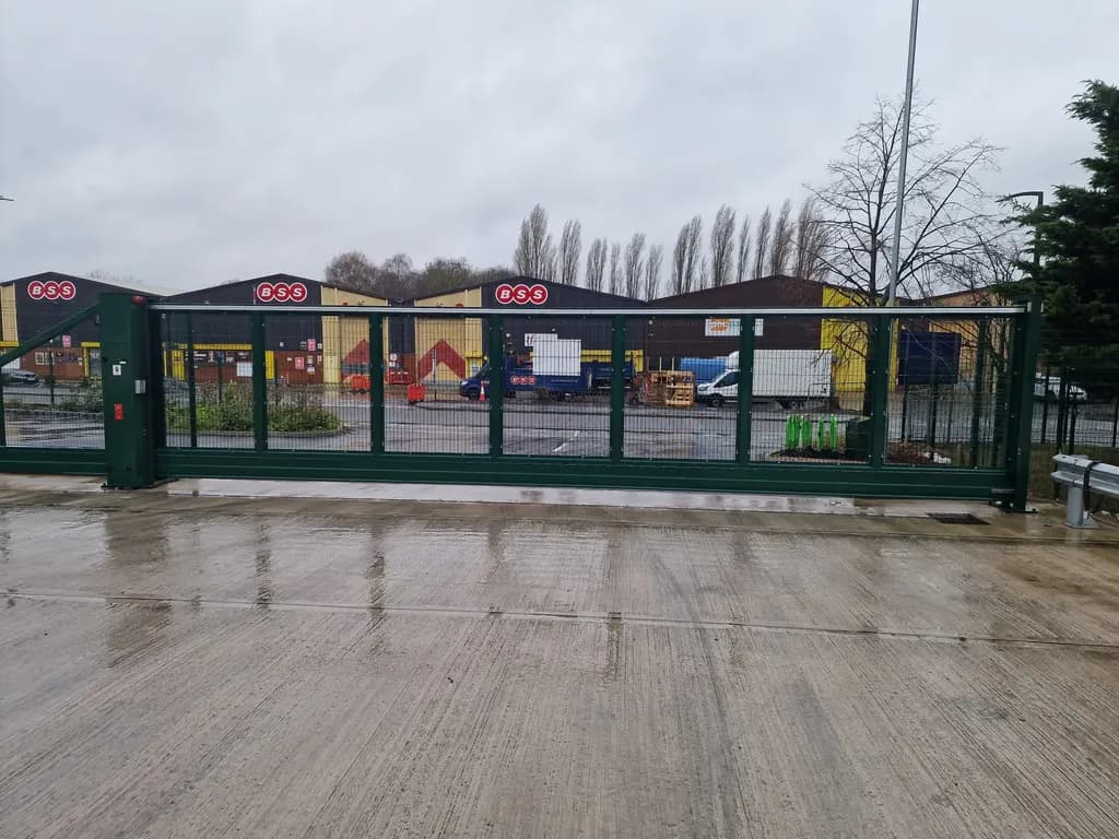 Green mesh gates closing the service yard of a retail park