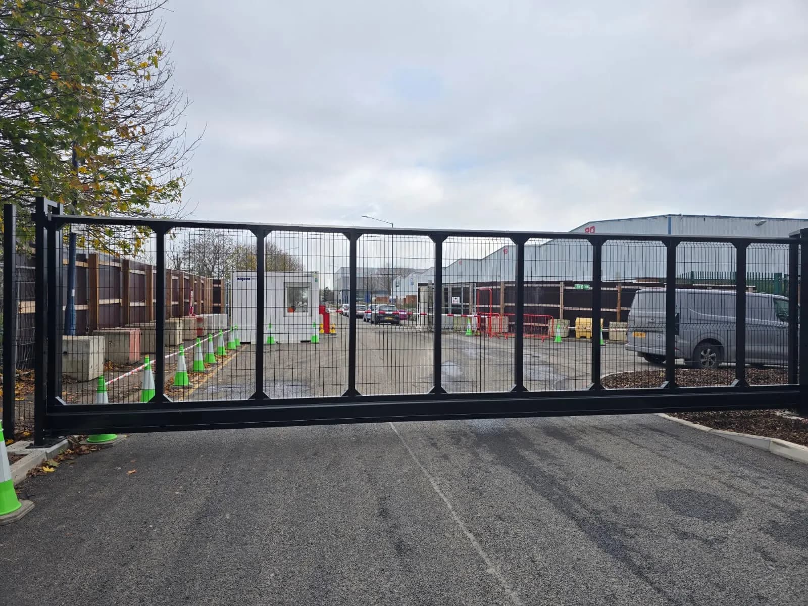 Mesh sliding gate on its track at the entrance to a distribution yard