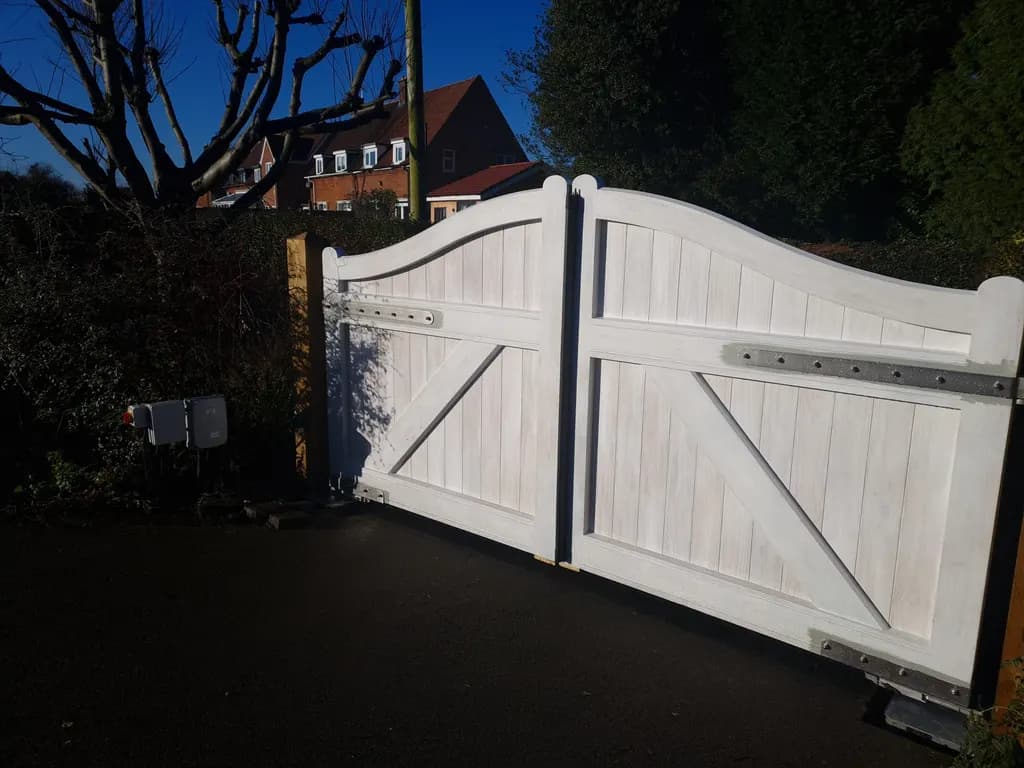 Painted timber gates photographed in the evening at a residential entrance