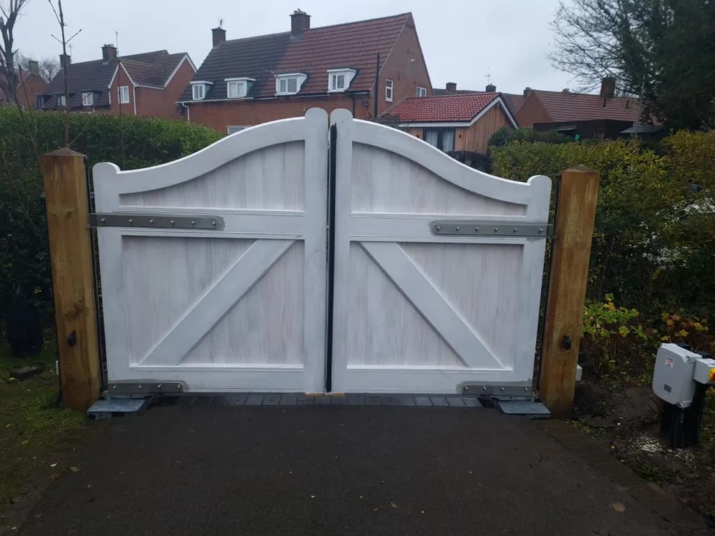 Painted timber gates automated at a residential entrance