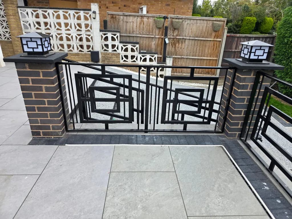 Decorative railings and matching gate around a paved patio