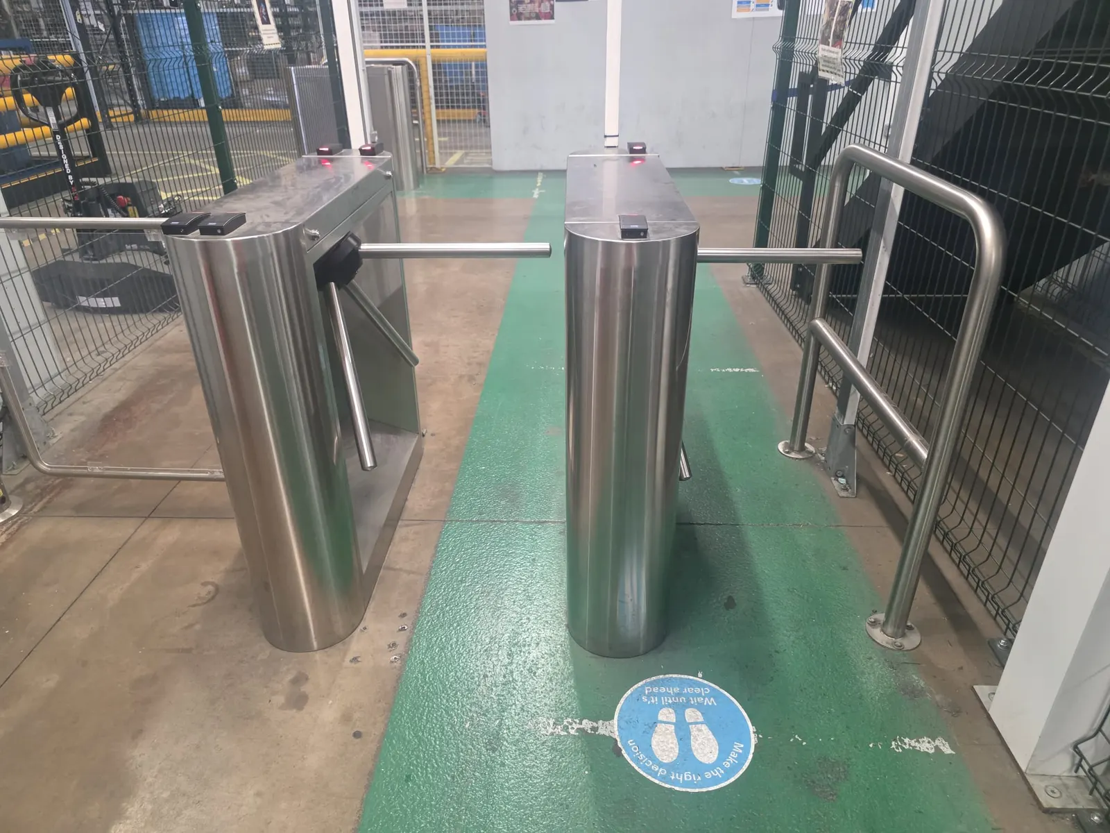 Stainless steel speed-gate turnstiles controlling access in a building reception