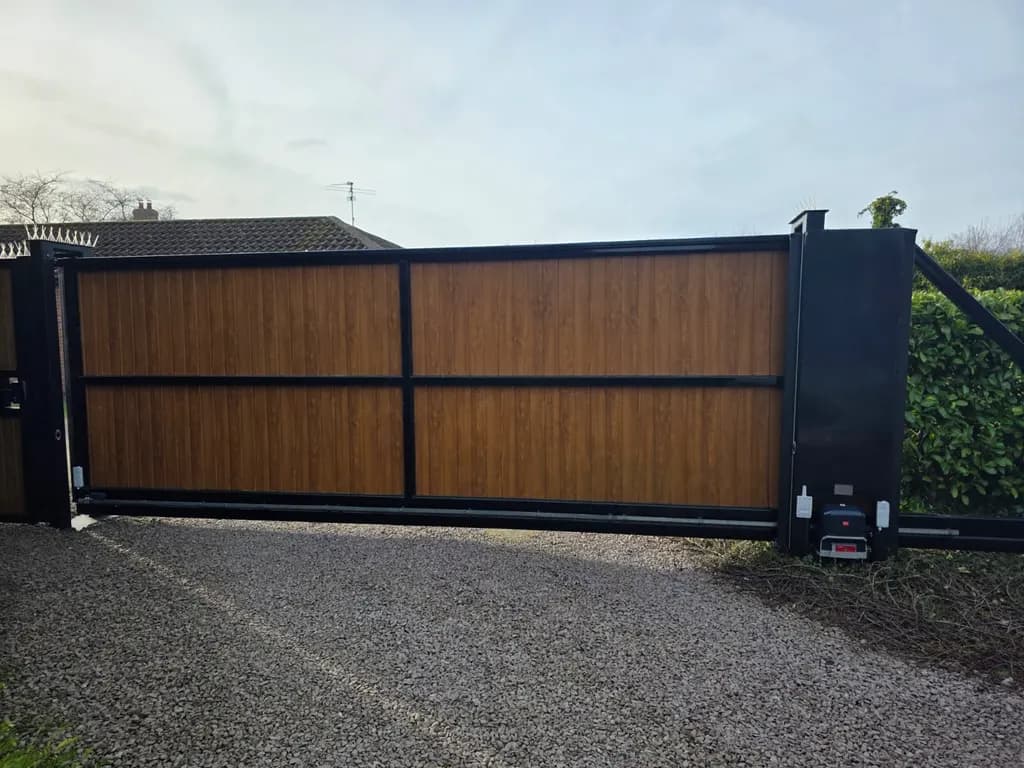 Timber-clad sliding gate on a steel frame with the operator housed at the closing post