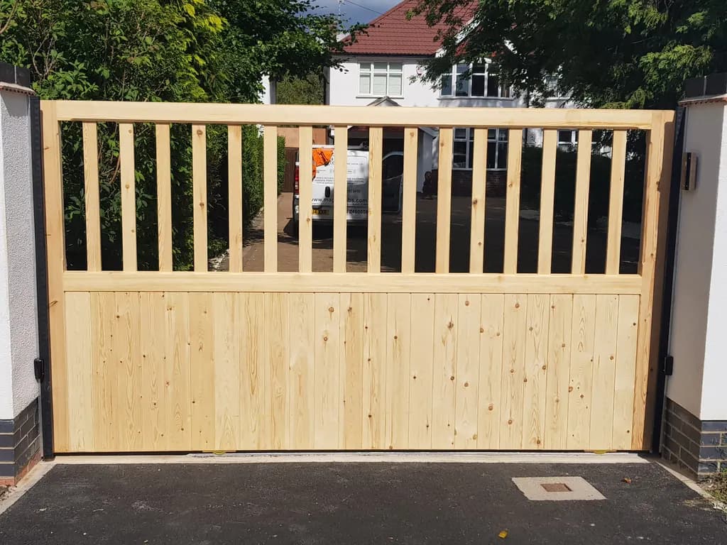 Timber gate with an open top rail, newly hung on a residential drive
