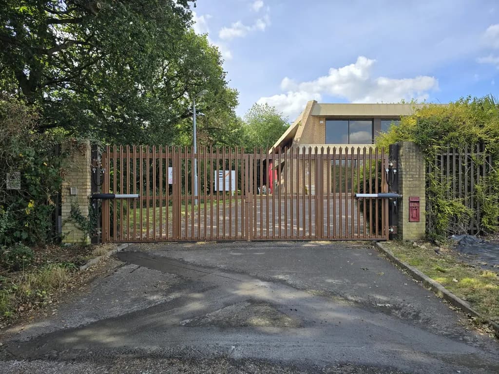 Timber gates with intercom and keypad at the entrance to a rural property