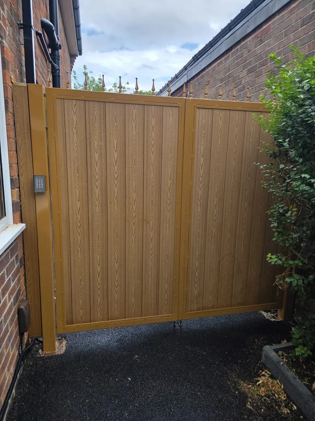 Timber pedestrian side gate beside a driveway entrance