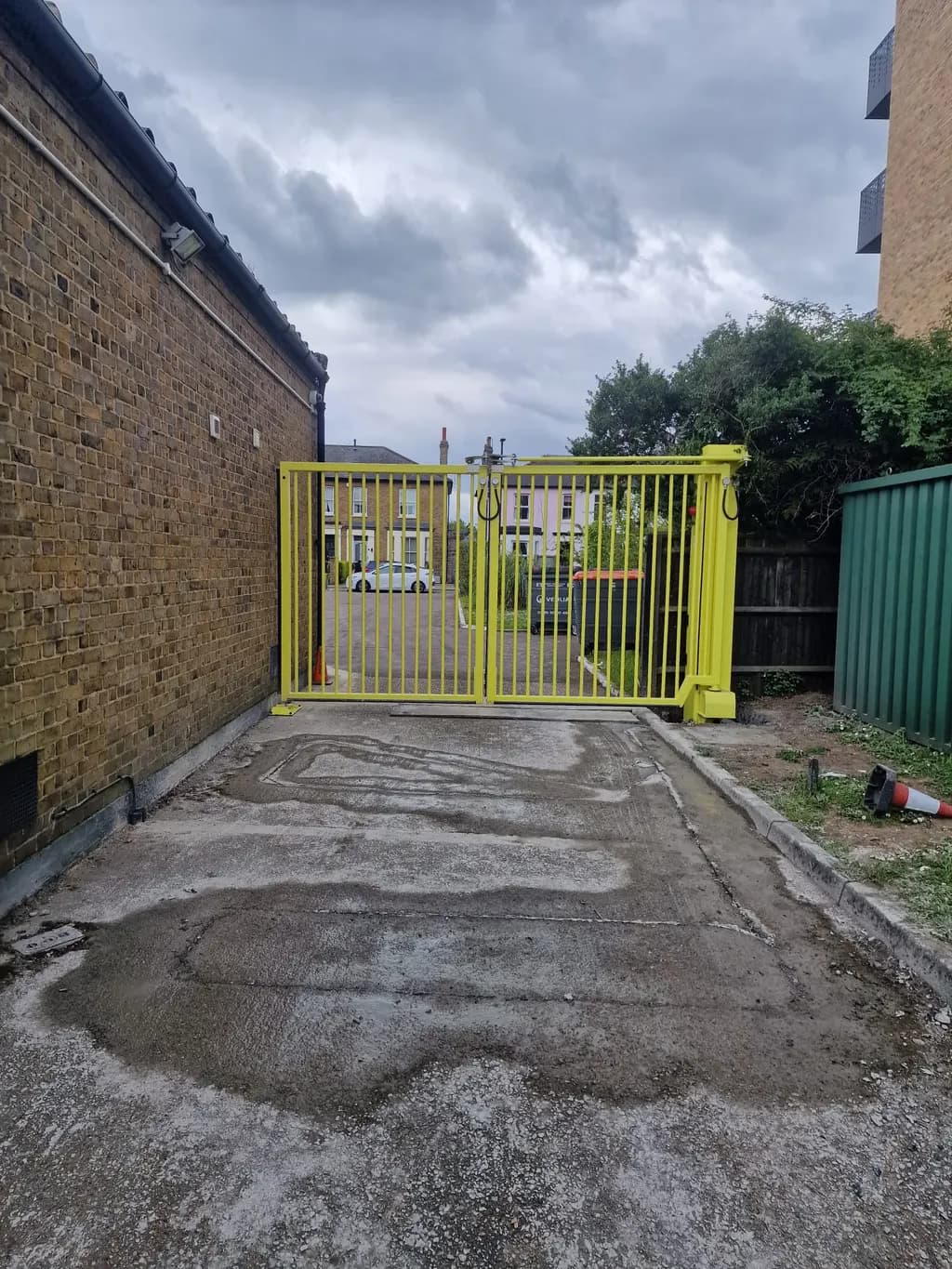 Yellow security gates closing a service alley between buildings